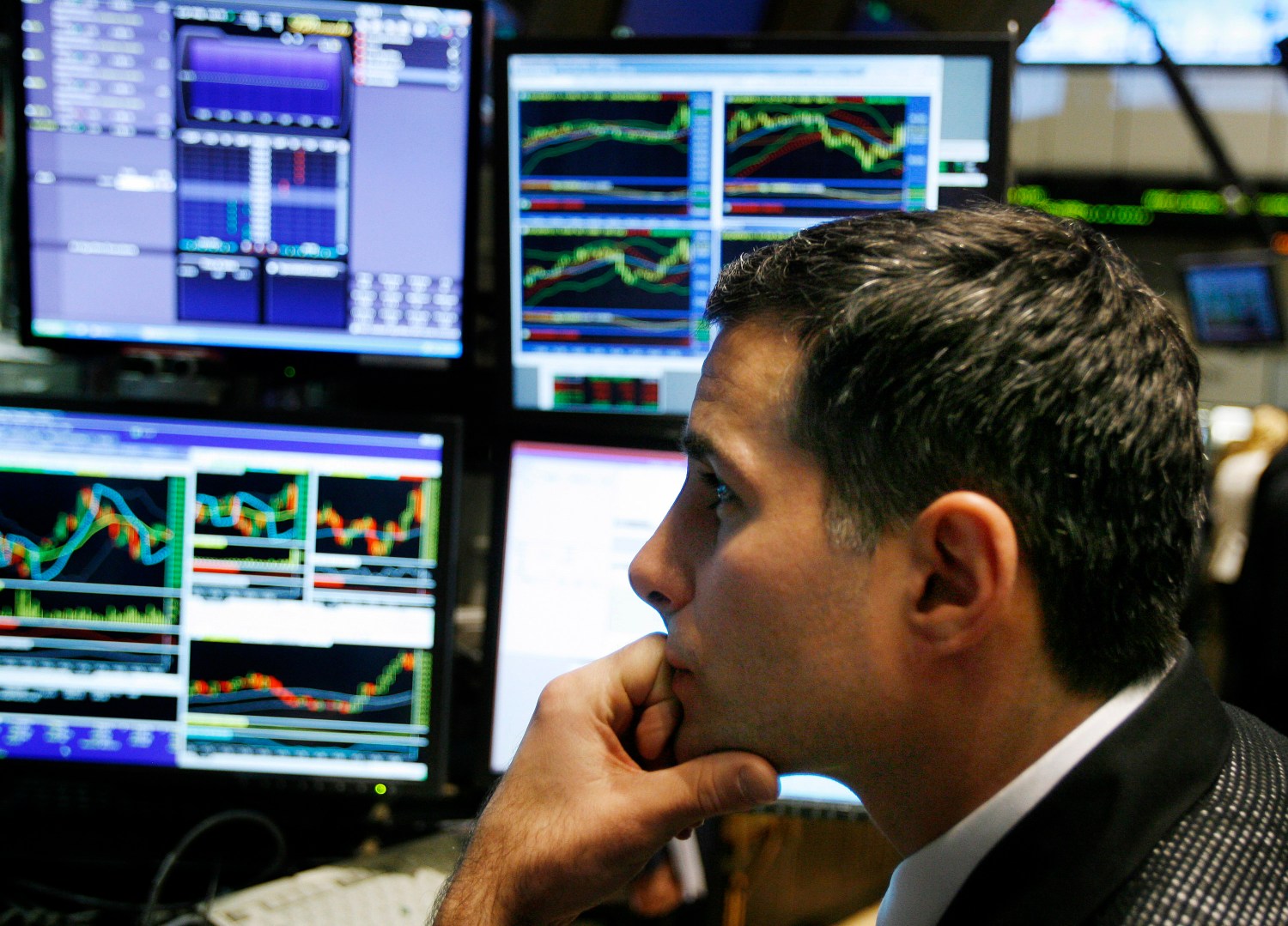 A specialist watches screens as he works on the floor of the New York Stock Exchange