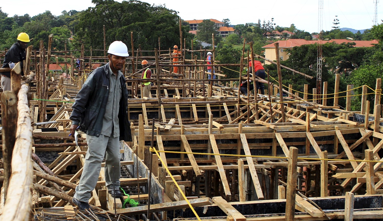 A construction worker checks on site progress of a new hospital in Hoima