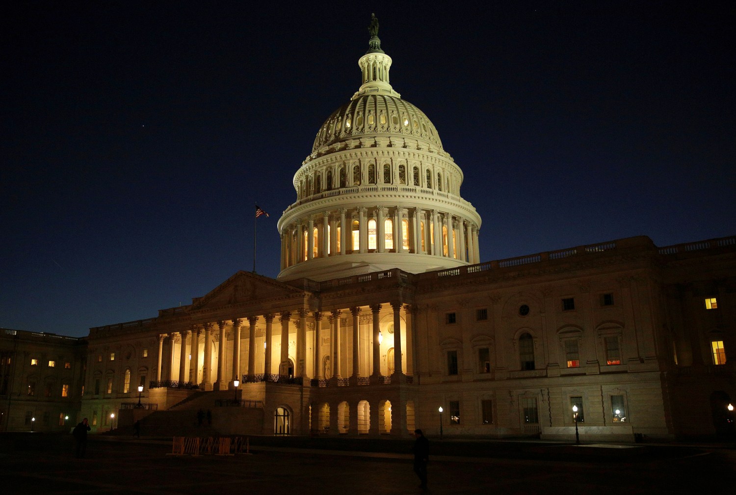 The U.S. Capitol Building is lit at sunset in Washington