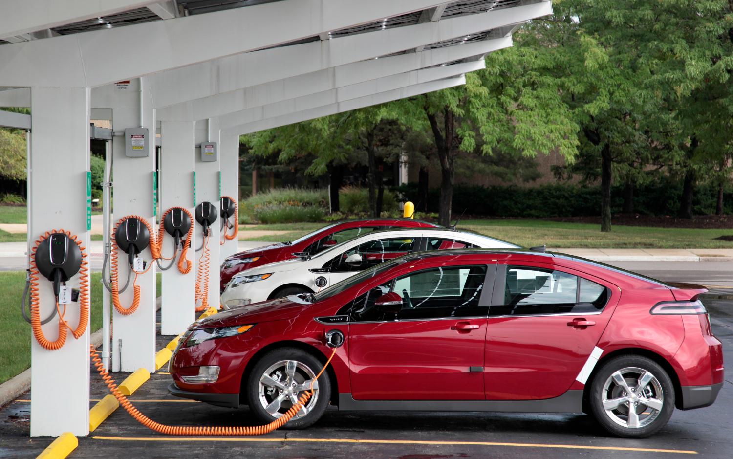 Chevrolet Volt electric vehicles are parked at solar-powered electric charging stations designed by Sunlogics in the parking lot of General Motors Co's assembly plant in Hamtramck