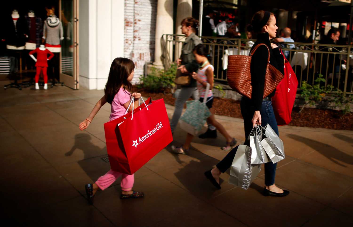 People shop at The Grove mall in Los Angeles