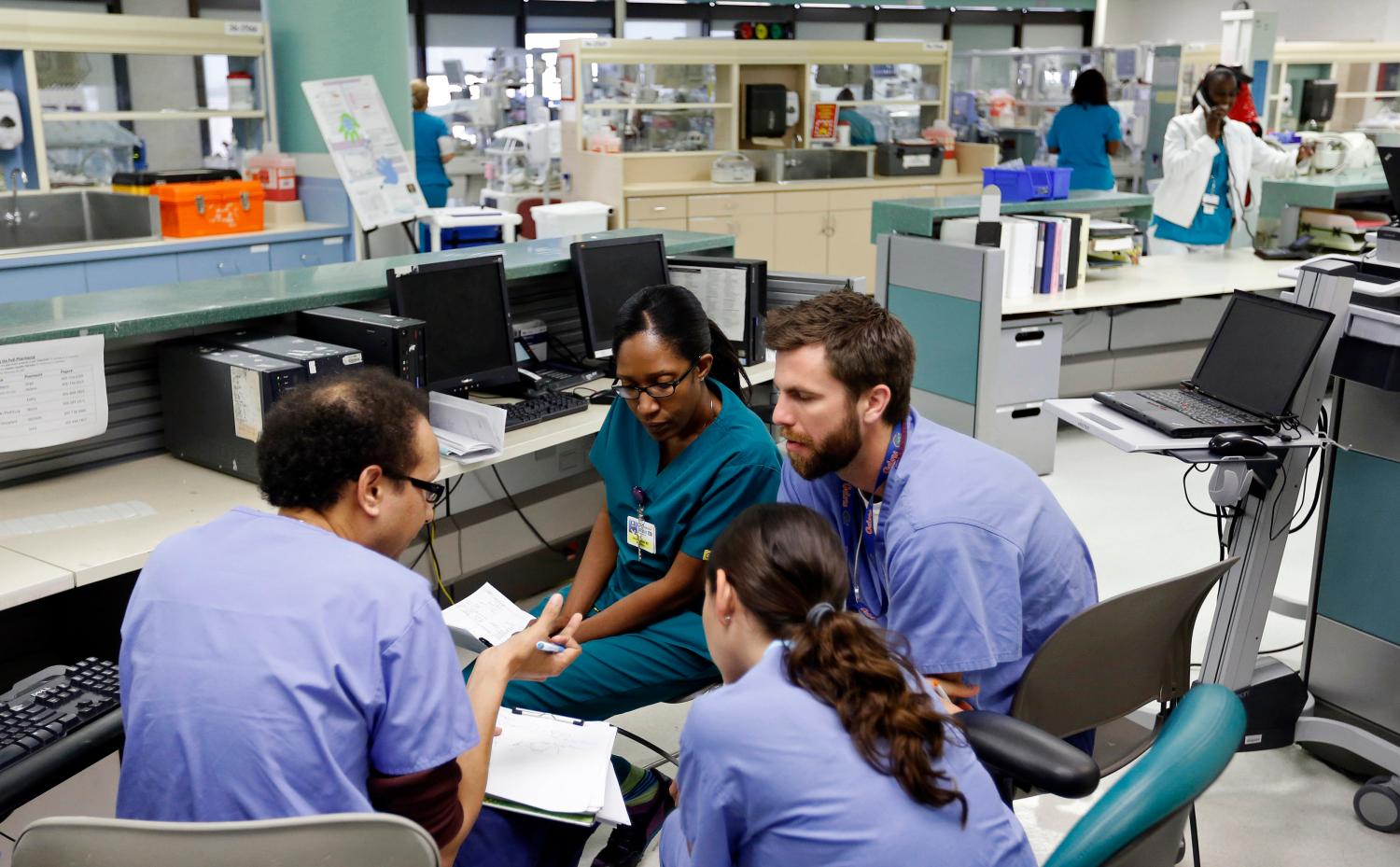 Doctors confer in the neonatal intensive care unit of the Holtz Children's Hospital at Jackson Memorial Hospital in Miami