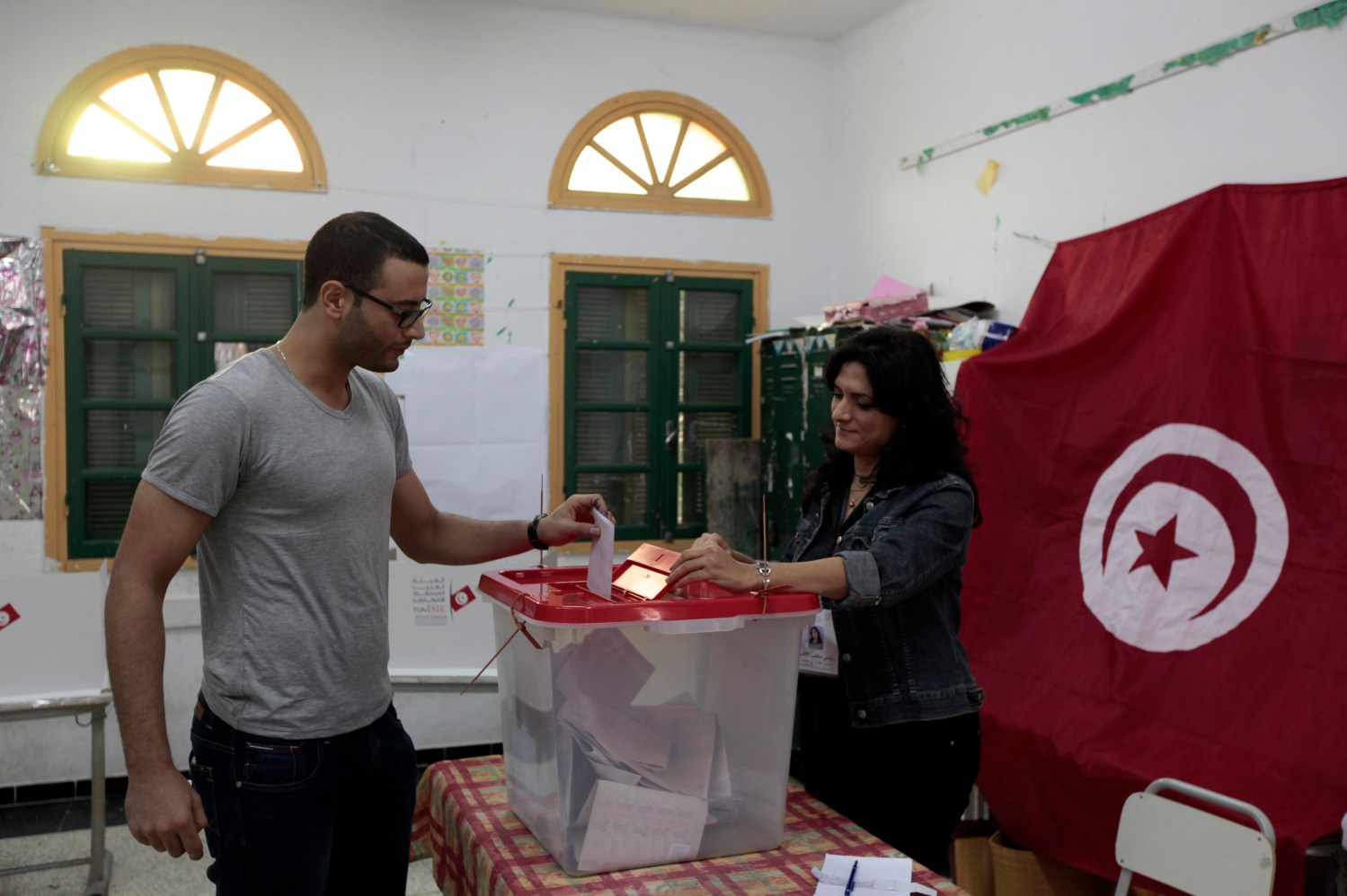 Tunisians cast their votes at a polling station during Tunisia's presidential election in Sousse