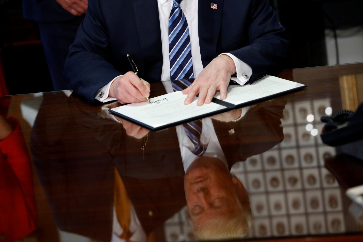 U.S. President Donald Trump signs an executive order