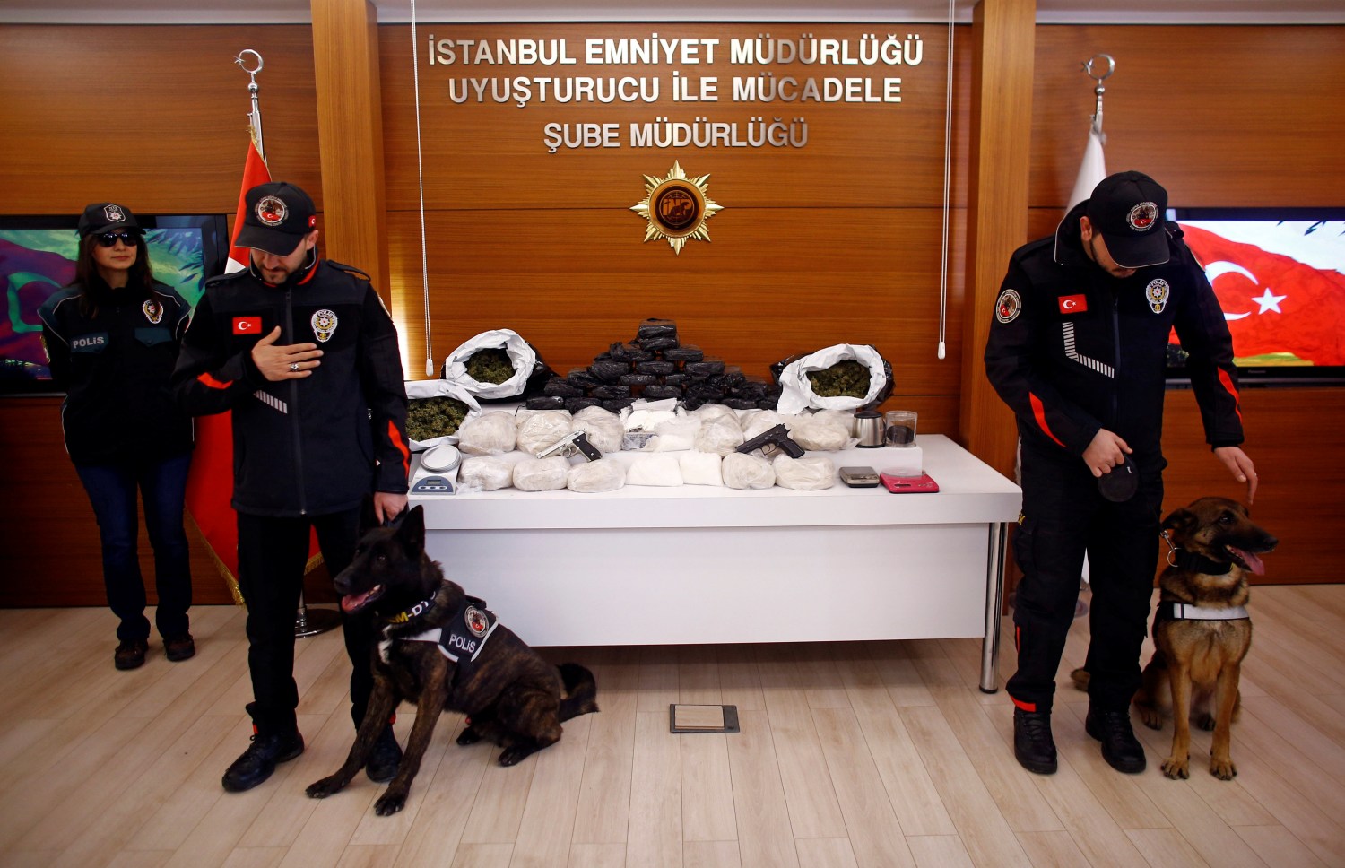 Turkish anti-drug police stand next to drugs and weapons, which according to Istanbul Police department are worth $3.6 million, that were seized during raids across Istanbul, Turkey March 27, 2017. REUTERS/Osman Orsal - RTX32WAY
