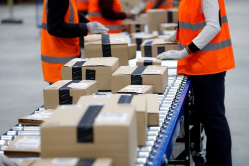 Amazon employees sort packages