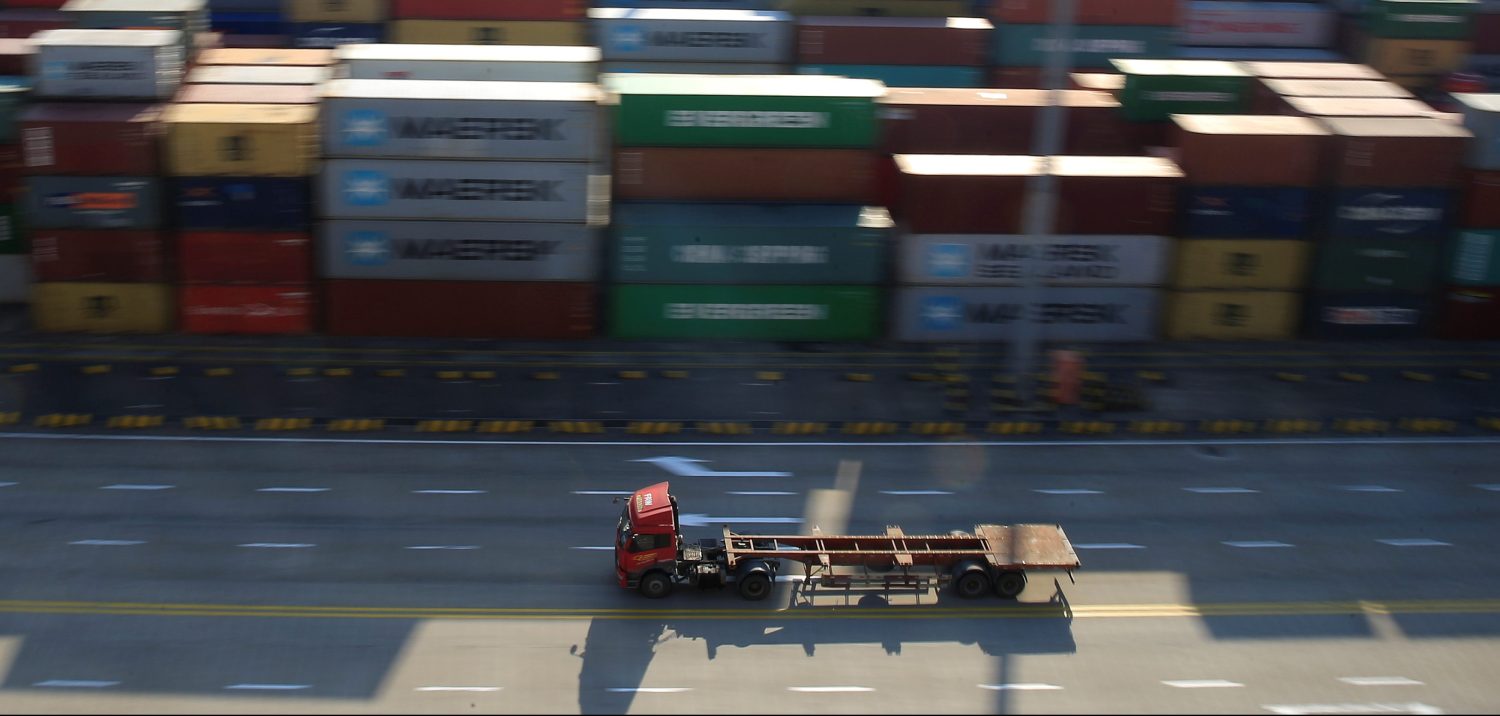 A truck drives past container boxes at the Yangshan Deep Water Port, part of the Shanghai Free Trade Zone, in Shanghai, China, February 13, 2017. REUTERS/Aly Song - RTSYG5J
