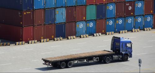 A truck drives past container boxes at the Yangshan Deep Water Port, part of the Shanghai Free Trade Zone, in Shanghai, China, September 24, 2016. Picture taken September 24, 2016. REUTERS/Aly Song - RTSPFVH