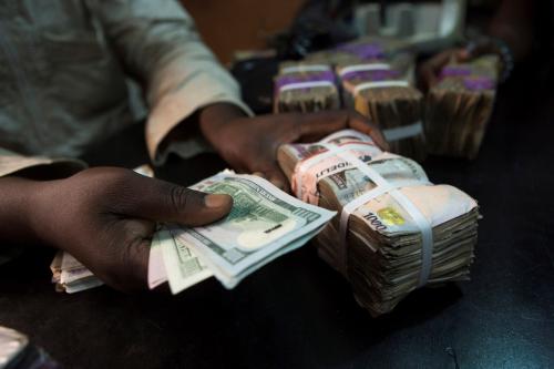 A trader changes dollars with naira at a currency exchange store in Lagos