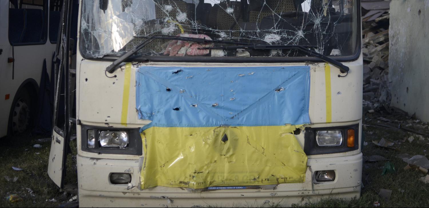 A shrapnel-hit bus belonging to Ukraine's "Donbas" battalion is seen in the eastern Ukrainian town of Ilovaysk August 24, 2014. REUTERS/Maks Levin (UKRAINE - Tags: POLITICS MILITARY CONFLICT) - RTR43IDU