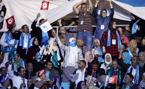 Supporters of the Ennahda movement holds flags during the movement's congress in Tunis,Tunisia May 20, 2016. REUTERS/Zoubeir Souissi - RTSF8BF