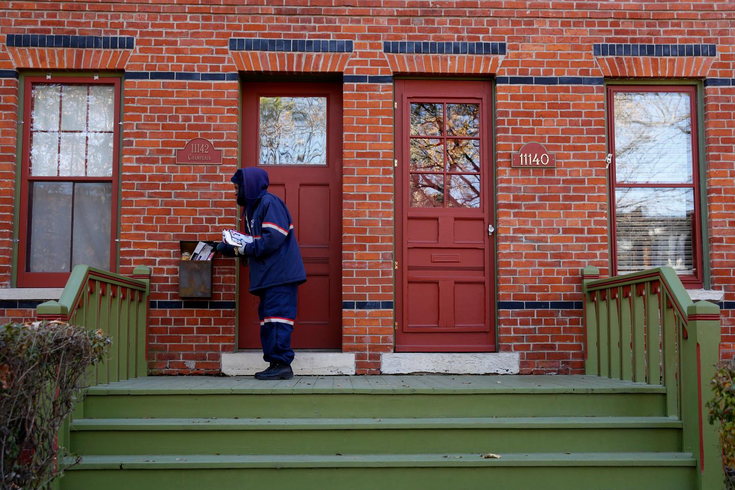 Mail carrier Marissa Ogletree delivers mail.