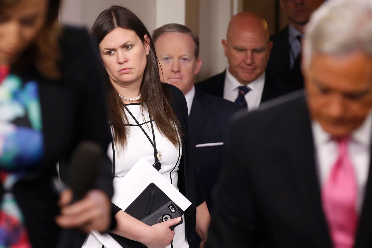 Deputy White House press secretary Sarah Huckabee Sanders (L-R) holds the door for Press Secretary Sean Spicer and White House national security advisor H.R. McMaster to speak in the White House briefing room in Washington, U.S., May 16, 2017. REUTERS/Joshua Roberts - RTX3638W