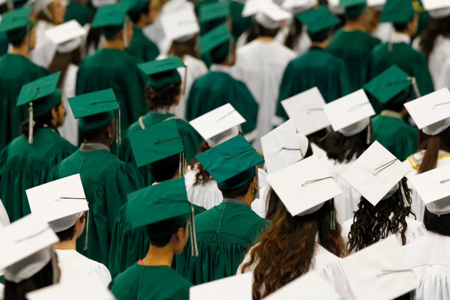 Reynolds High School students observe a moment of silence during graduation ceremony at the Veterans Memorial Coliseum, Portland