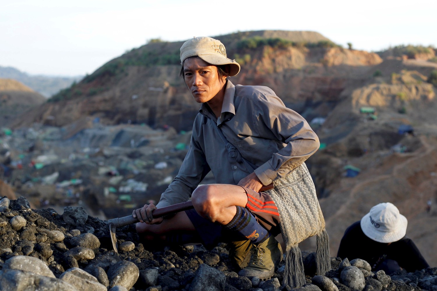 DATE IMPORTED:November 27, 2015A miner sits in a mine as he searches for jade stones at Hpakant jade mine in Kachin state, Myanmar, November 27, 2015. REUTERS/Soe Zeya Tun