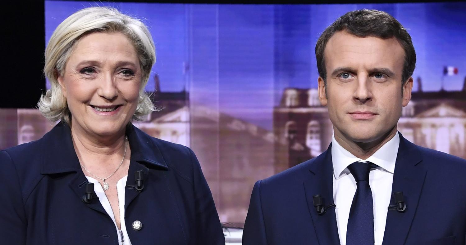 Candidates for the 2017 presidential election, Emmanuel Macron (R), head of the political movement En Marche !, or Onwards !, and Marine Le Pen, of the French National Front (FN) party, pose prior to the start of a live prime-time debate in the studios of French television station France 2, and French private station TF1 in La Plaine-Saint-Denis, near Paris, France, May 3, 2017. REUTERS/Eric Feferberg/Pool