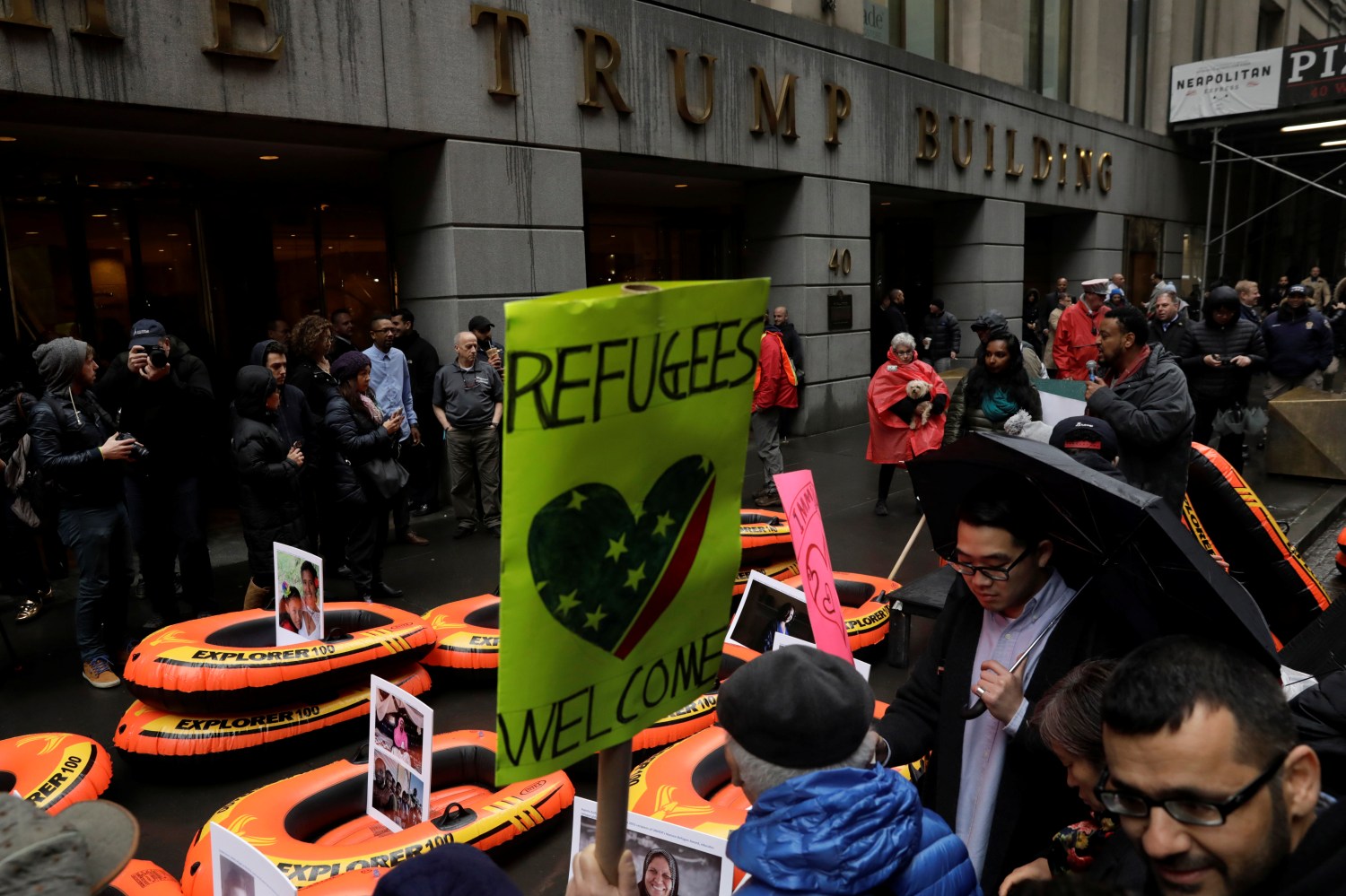 Protesters gather outside the Trump Building at 40 Wall St. to take action against Americas refugee ban in New York City, U.S., March 28, 2017. REUTERS/Lucas Jackson - RTX333GZ