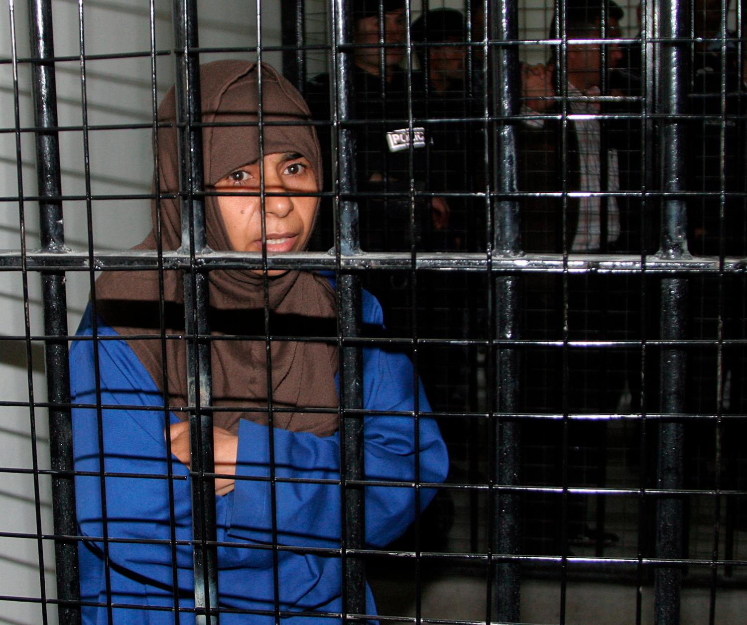 Iraqi Sajida al-Rishawi, 35, stands inside a military court at Juwaida prison in Amman April 24, 2006. Sajida will stand trial on Monday in a state security court for the attacks on three Amman hotels on November 9 by her husband and two other male Iraqi suicide bombers. Rishawi has been charged with conspiracy to carry out terrorist acts, causing death and destruction, and the illegal possession of weapons and explosives, and faces a death sentence if found guilty.
