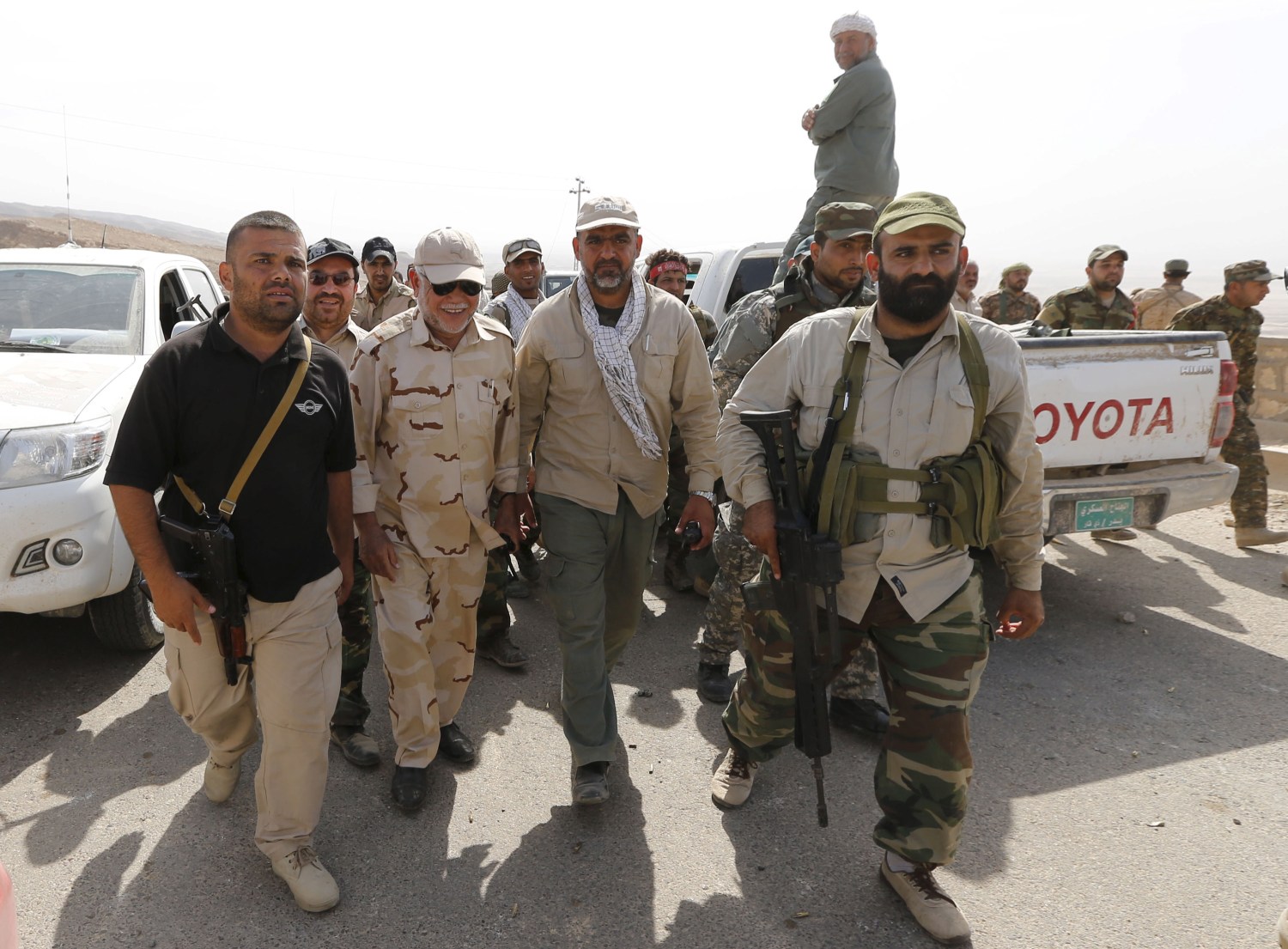 Head of the Badr Organisation Hadi al-Amiri (C, L) walks with Shi'ite fighters in Makhoul mountains, north of Baiji, October 17, 2015. Iraqi forces and Shi'ite militia fighters recaptured most of the countrys largest oil refinery from Islamic State militants on Thursday, security officials said. The report could not be independently confirmed because it is too dangerous for journalists to enter the battle zone around the refinery near the town of Baiji, about 190 km (120 miles) north of Baghdad.