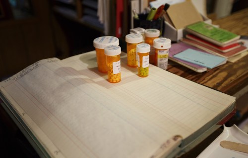 Patient's prescriptions sit on a handwritten ledger in Dr. Byron Harbolt's Cathedral Canyon Clinic in Altamont, Tennessee July 14, 2013. Harbolt, 89, who charges as little as $15 for an office visit, sees patients six days a week in the rural clinic he opened in 1960. Photo taken July 14, 2013. REUTERS/Harrison McClary (UNITED STATES - Tags: HEALTH SOCIETY) - RTX11NNB