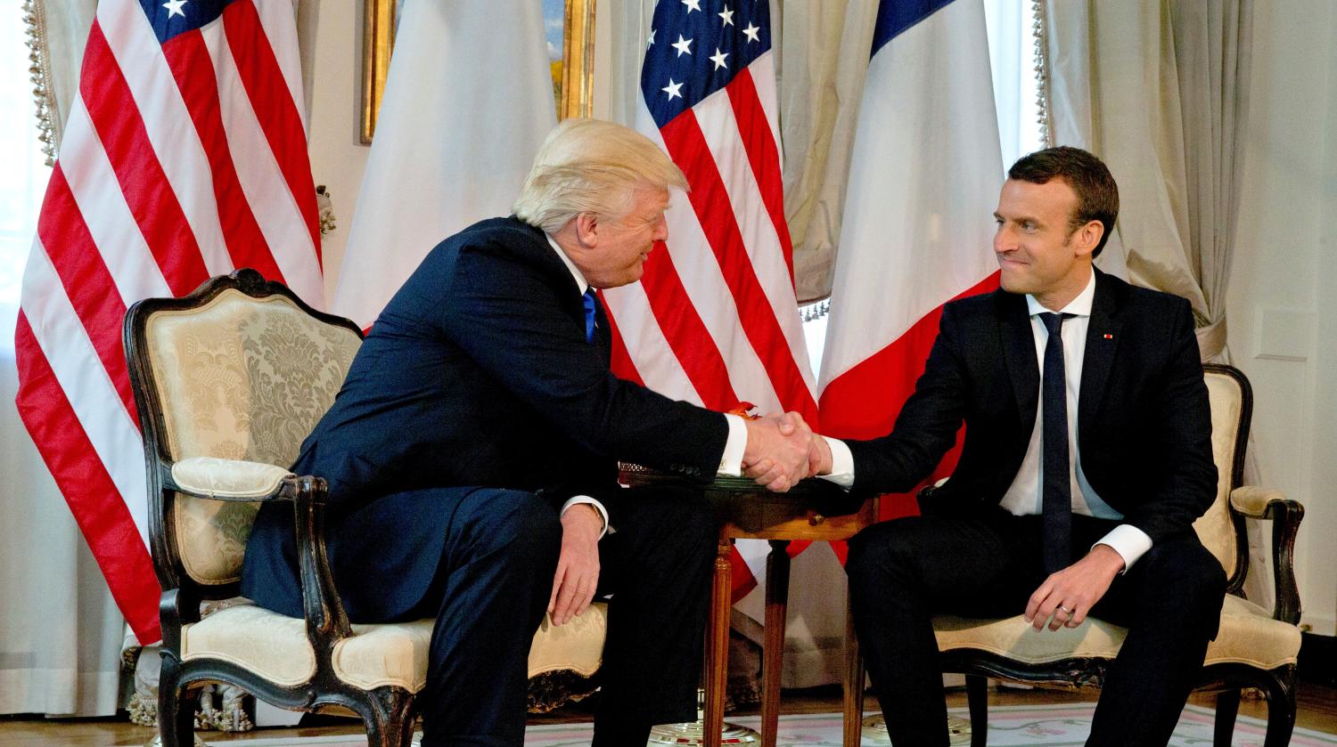 U.S. President Donald Trump (L) shakes hands with French President Emmanuel Macron before a working lunch ahead of a NATO Summit in Brussels, Belgium, May 25, 2017. REUTERS/Peter Dejong/Pool - RTX37KVY