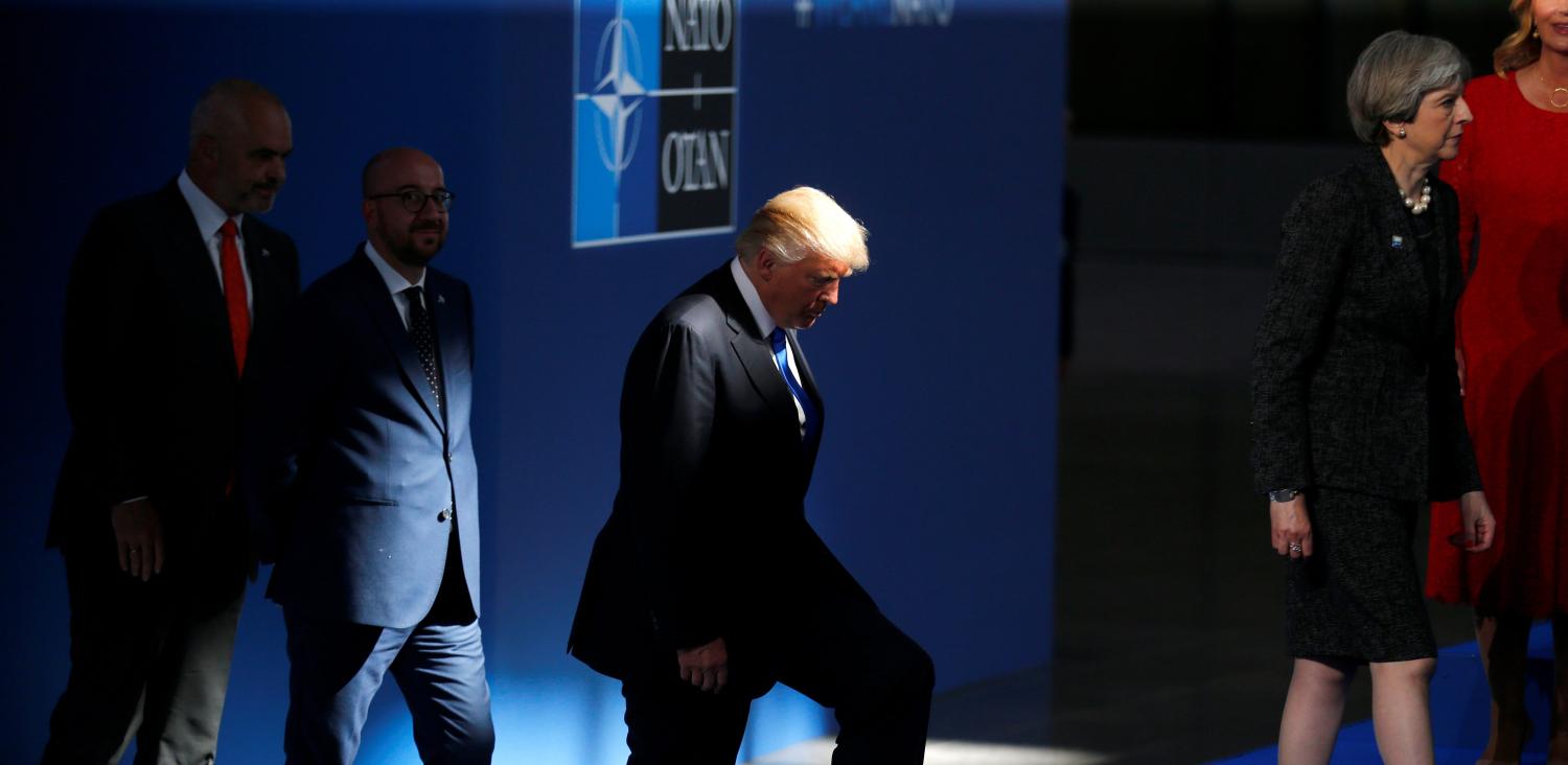 U.S President Donald Trump (C) follows Britain's Prime Minister Theresa May as NATO member leaders gather before the start of their summit in Brussels, Belgium, May 25, 2017. REUTERS/Hannibal Hanschke - RTX37MO6