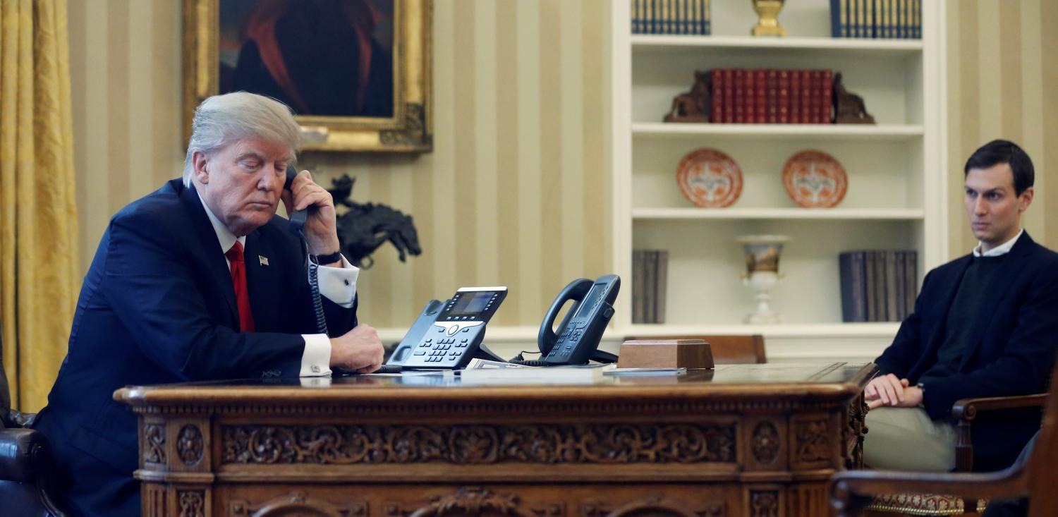 U.S. President Donald Trump, joined by his senior advisor and son-in-law Jared Kushner (R), speaks by phone with the Saudi Arabia's King Salman in the Oval Office at the White House in Washington, U.S. January 29, 2017. REUTERS/Jonathan Ernst - RTSXXV8