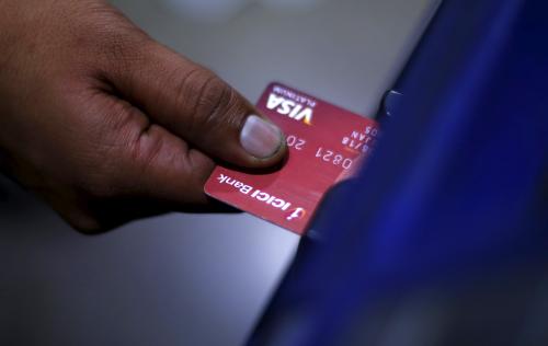 A man uses an ATM.