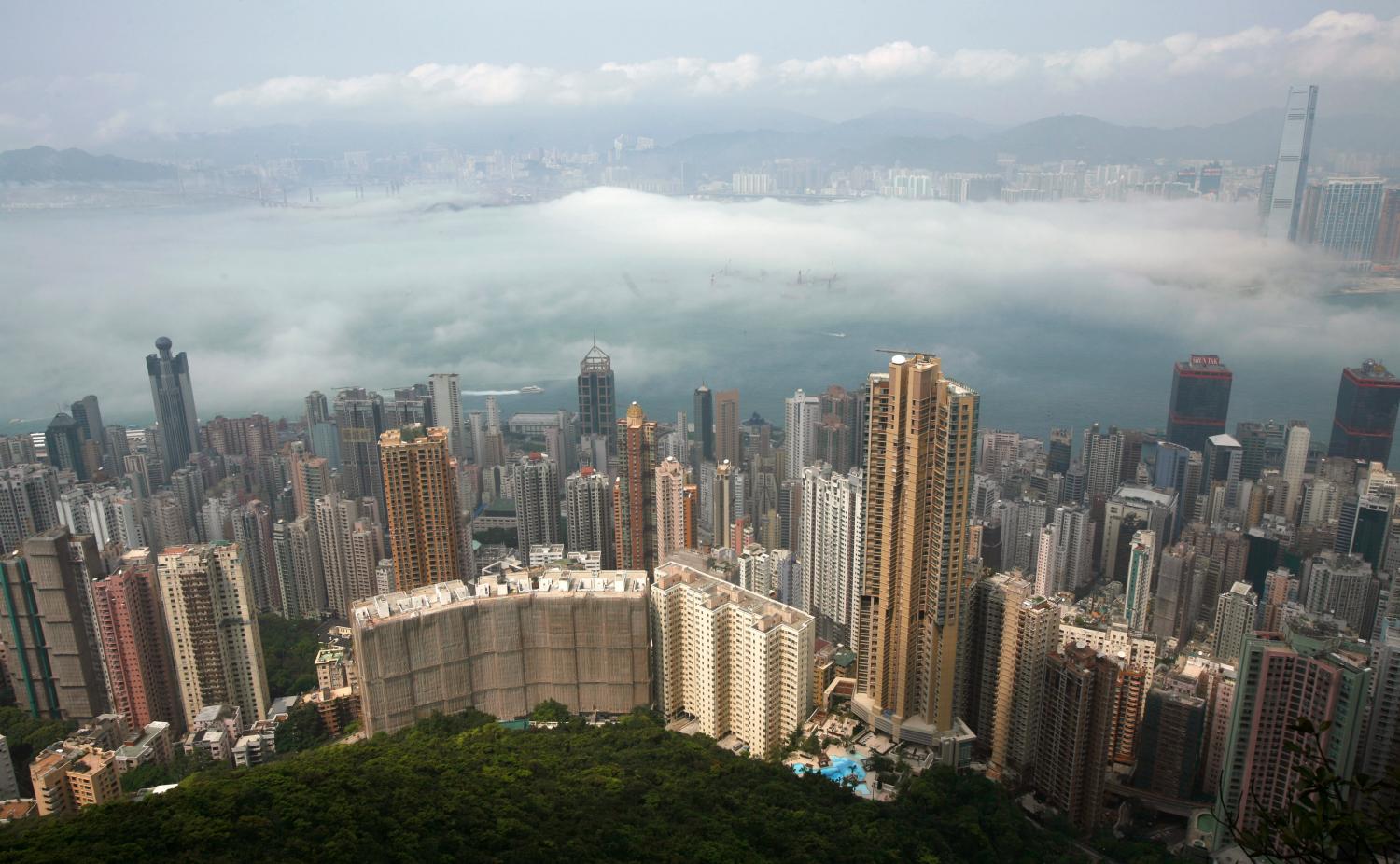 An aerial view of Hong Kong's cityscape during foggy conditions March 15, 2010. A humid maritime airstream is affecting the south China coastal areas, the Hong Kong observatory reported on Monday. REUTERS/Bobby Yip (CHINA - Tags: ENVIRONMENT CITYSCAPE) - RTR2BNSE