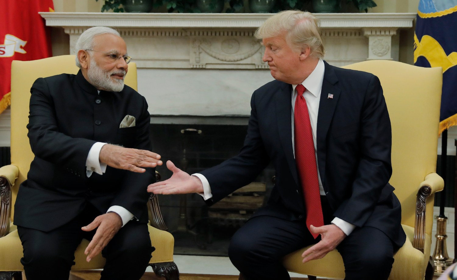 U.S. President Donald Trump (R) greets Indian Prime Minister Narendra Modi