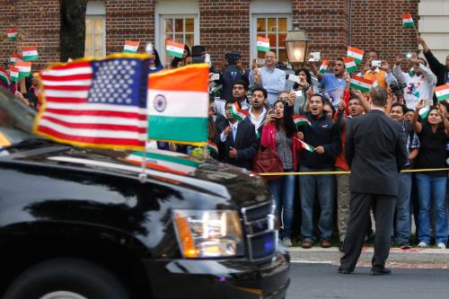 A crowd cheers as the motorcade carrying India's Prime Minister Narendra Modi arrives for him to pay homage at the Mahatma Gandhi Statue in front of the Indian Embassy in Washington September 30, 2014.