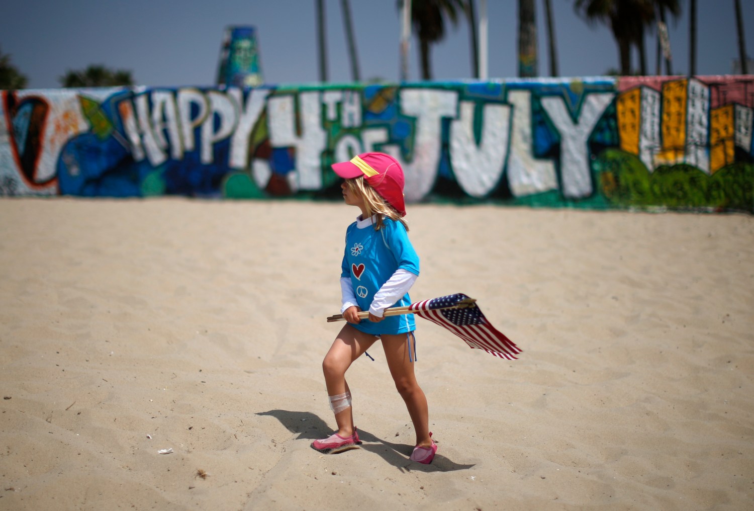 Child in front of a 4th of July mural