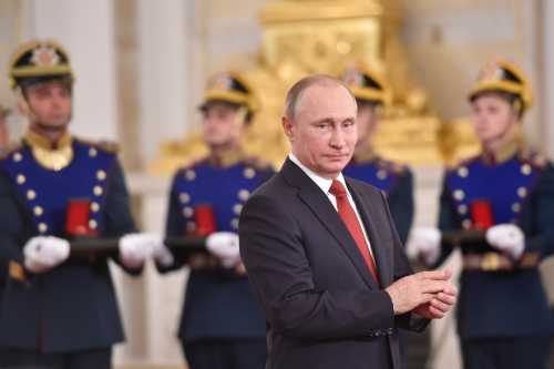 Russian President Vladimir Putin applauds during the State Prize