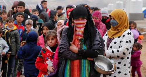 People who fled the Islamic State stronghold of Mosul, stand in line to receive food at a refugee camp, Iraq,December 18, 2016.REUTERS/Ammar Awad - RTX2VJJI