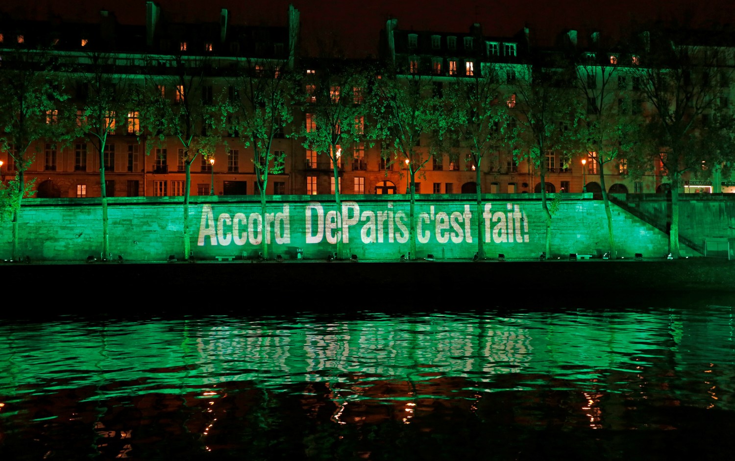 The banks of the Seine river is illuminated in green with the words "Paris Agreement is Done", to celebrate the Paris U.N. COP21 Climate Change agreement in Paris