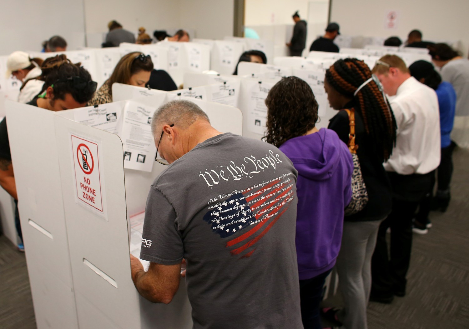 A voter wears a shirt with words from the United States Constitution while casting his ballot early as long lines of voters vote at the San Diego County Elections Office in San Diego, California, U.S., November 7, 2016.