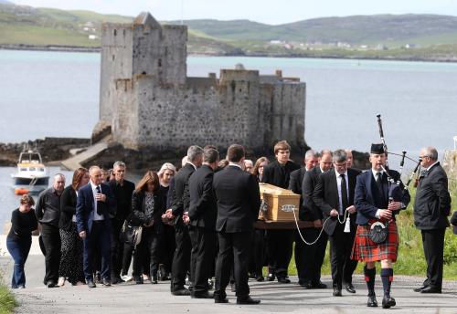 Roddy MacLeod father of Manchester bomb victim Eilidh MacLeod leads the funeral procession as it passes Kisimul Castle on its way to the Church of Our Lady, Star of the Sea, ahead of the funeral of Manchester bomb victim Eilidh MacLeod, in Castlebay on the island of Barra, in Scotland June 5, 2017. REUTERS/Andrew Milligan/Pool