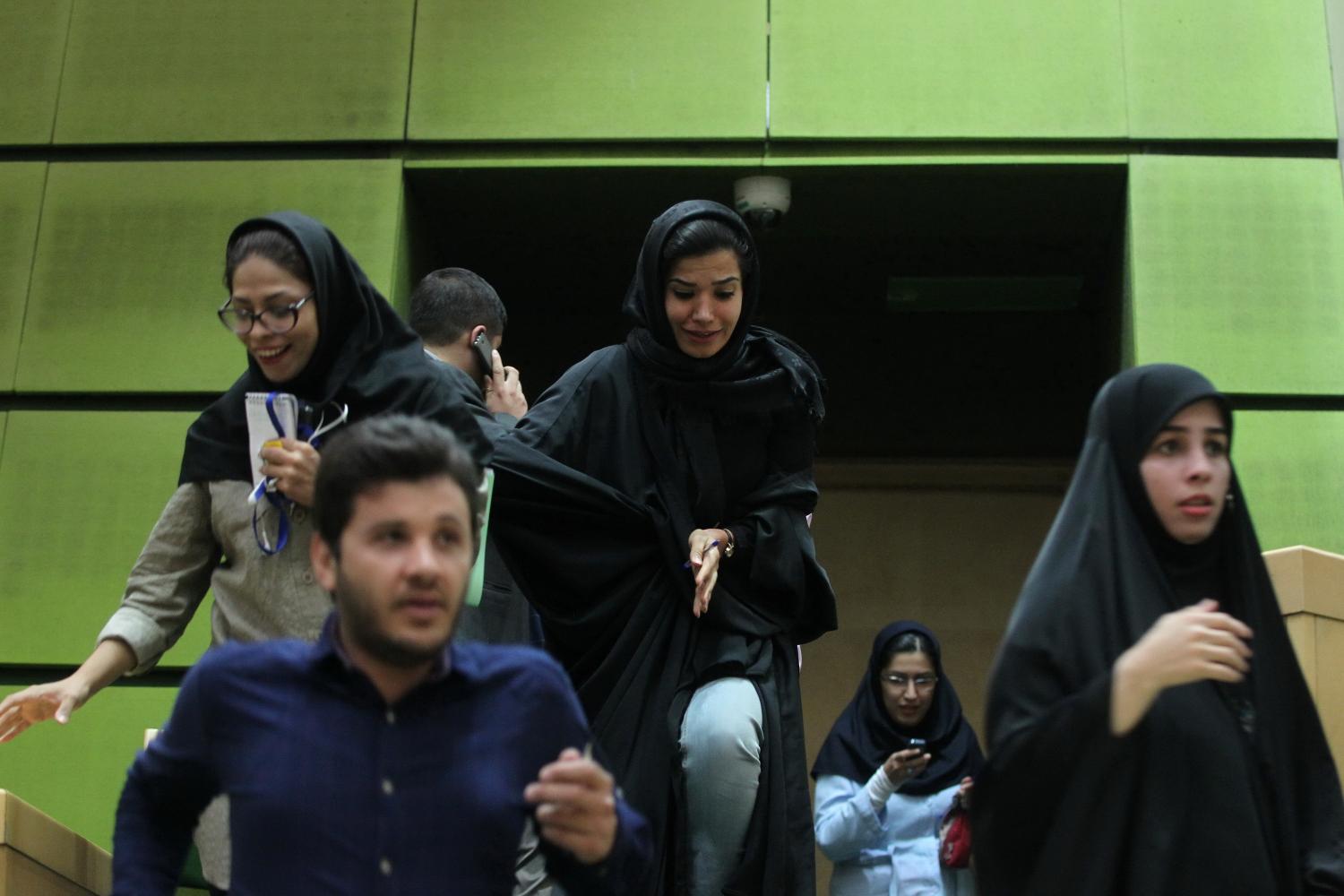Women are seen inside the parliament during an attack in central Tehran, Iran, June 7, 2017. TIMA via REUTERS ATTENTION EDITORS - THIS IMAGE WAS PROVIDED BY A THIRD PARTY. FOR EDITORIAL USE ONLY. - RTX39FJN