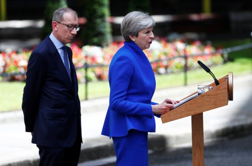 Britain's Prime Minister Theresa May makes a statement in Downing Street next to her husband Philip after traveling to Buckingham Palace to ask the Queen's permission to form a minority government