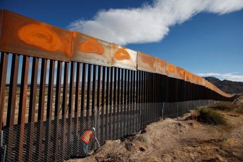 A U.S. worker inspects a section of the U.S.-Mexico border wall at Sunland Park, U.S. opposite t