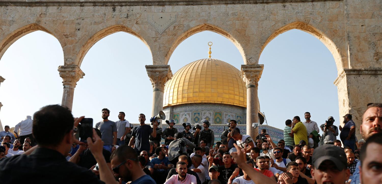 Palestinians gather at the compound known to Muslims as Noble Sanctuary and to Jews as Temple Mount, after Israel removed all security measures it had installed at the compound, in Jerusalem's Old City July 27, 2017. REUTERS/Muammar Awad - RTX3D5LZ