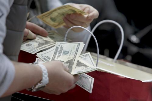 People count money at Macy's Herald Square store during the early opening of the Black Friday sales in the Manhattan borough of New York.