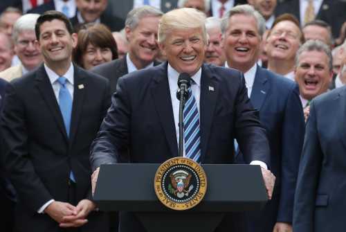 U.S. President Donald Trump (C) celebrates with Congressional Republicans.