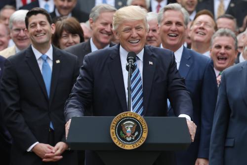 U.S. President Donald Trump (C) celebrates with Congressional Republicans.