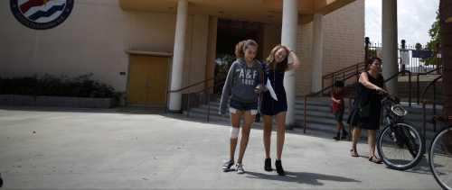 People walk out of South Pasadena High School in South Pasadena