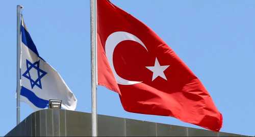 A Turkish flag flutters atop the Turkish embassy as an Israeli flag is seen nearby, in Tel Aviv, Israel June 26, 2016. REUTERS/Baz Ratner/File Photo - RTX2LGJ5