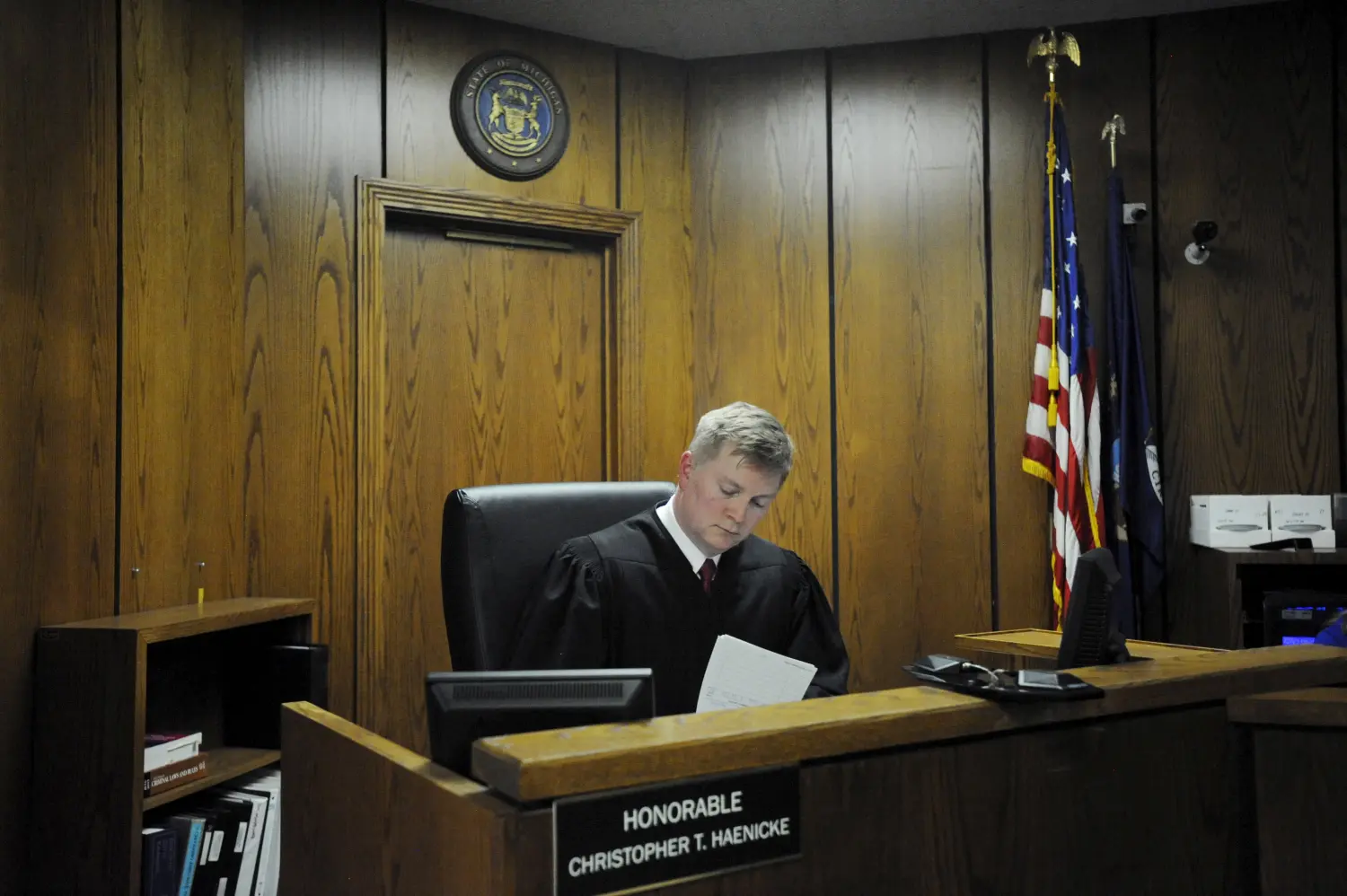 Judge Christopher Haenicke fills out paperwork