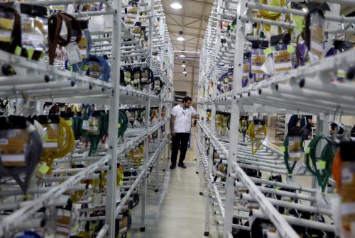 Workers of Leoni industries assemble electric parts for vehicles to be exported to Brazil in San Lorenzo, Paraguay December 15, 2016. REUTERS/Jorge Adorno - RTS1084K