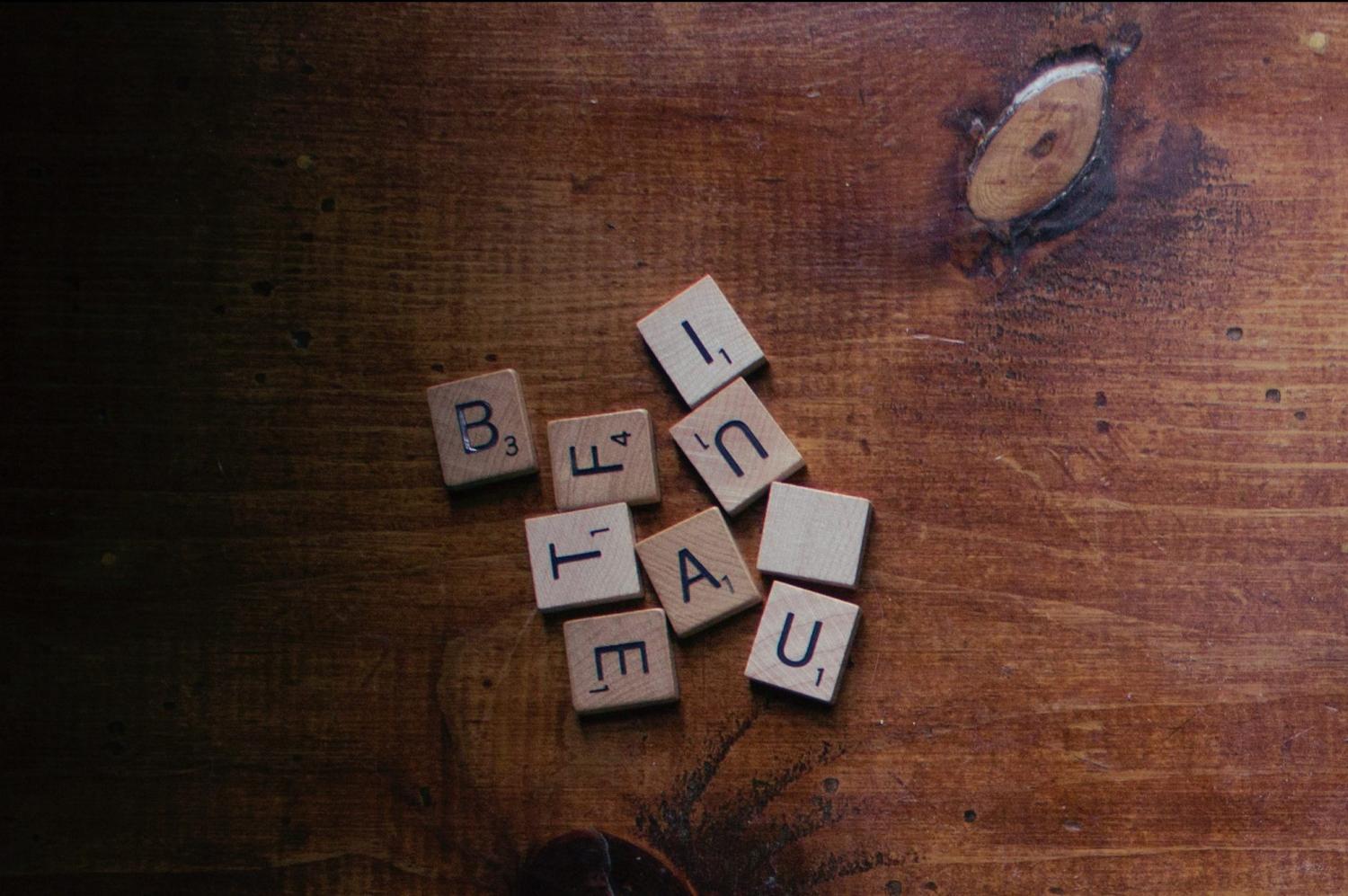 Scrabble pieces lying on a wooden table
