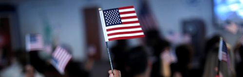 New American citizens wave American flags after taking the Oath of Allegiance during a naturalization ceremony in Newark, New Jersey, U.S., March 1, 2017. REUTERS/Mike Segar - RTS110PR